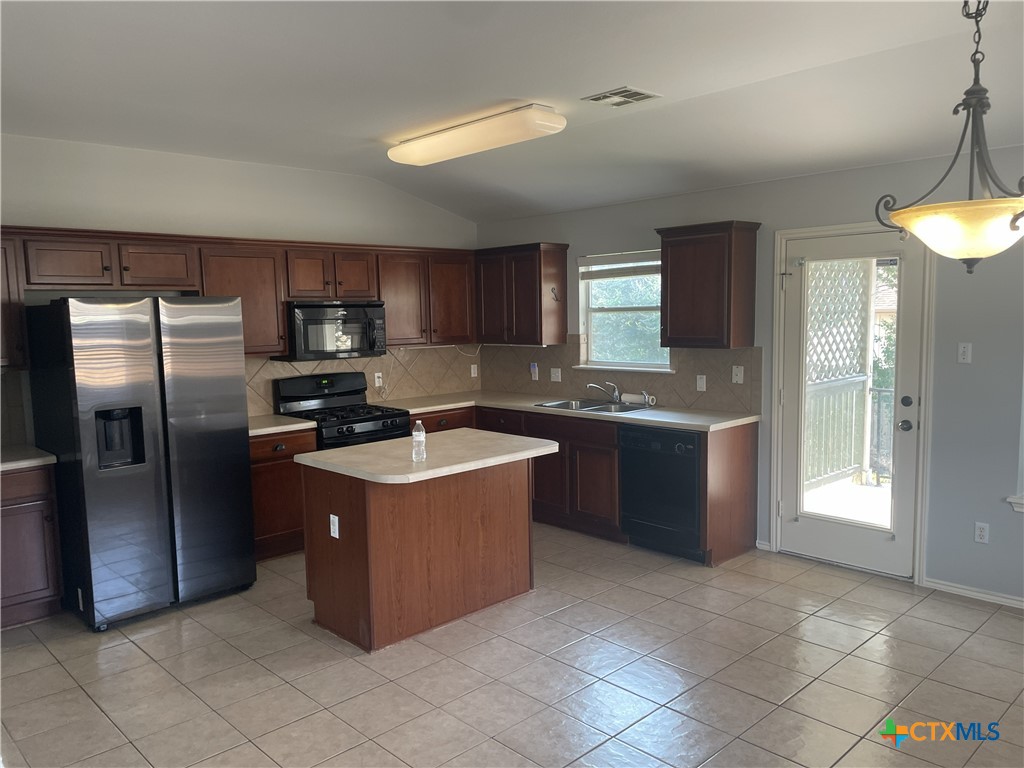 3208 Clinton Place Round Rock, TX 78665 - Photo 3 of 9 a kitchen with stainless steel appliances granite countertop a stove a refrigerator and a sink