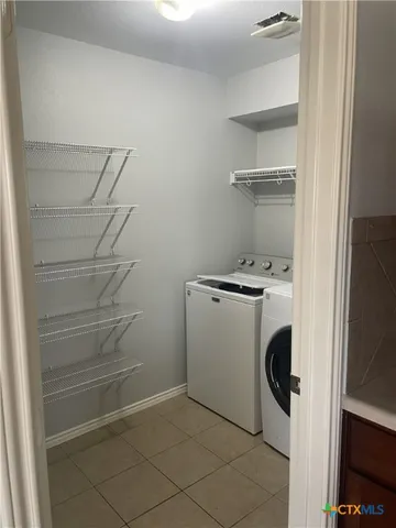 a utility room with washer and dryer