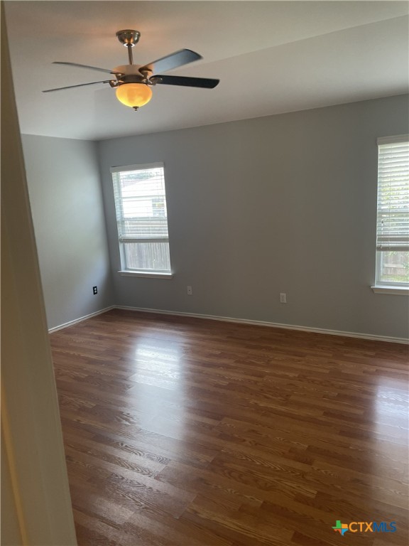 3208 Clinton Place Round Rock, TX 78665 - Photo 5 of 9 an empty room with wooden floor and windows