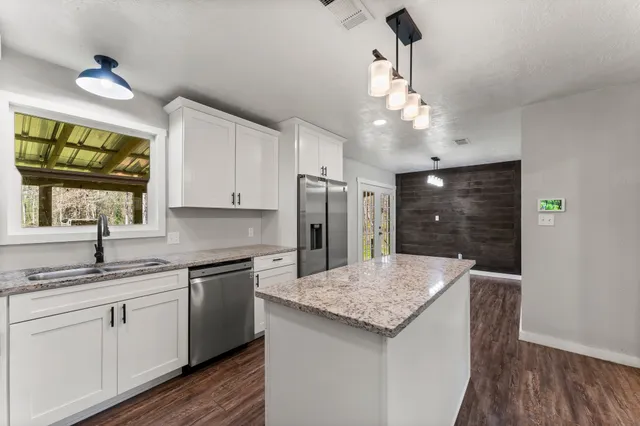 a kitchen with a sink and refrigerator