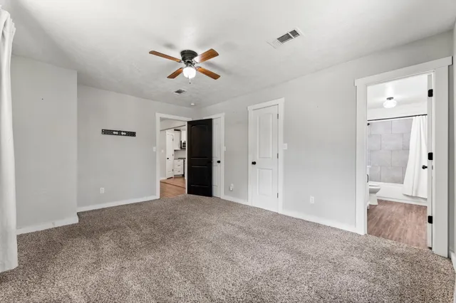 a view of a big room with closet and windows