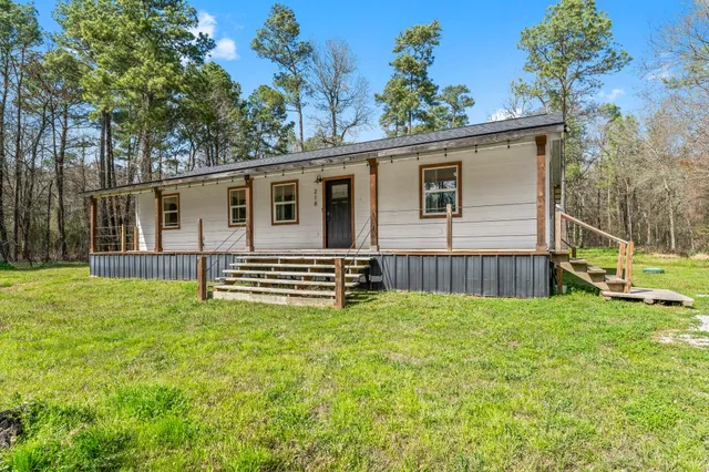 a view of a backyard with a small cabin