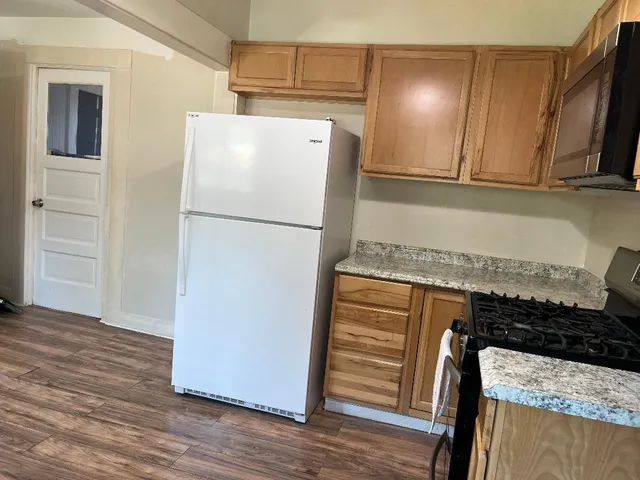 a white refrigerator freezer sitting inside of a kitchen