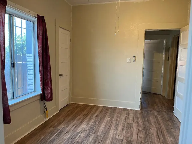 wooden floor in an empty room and a window