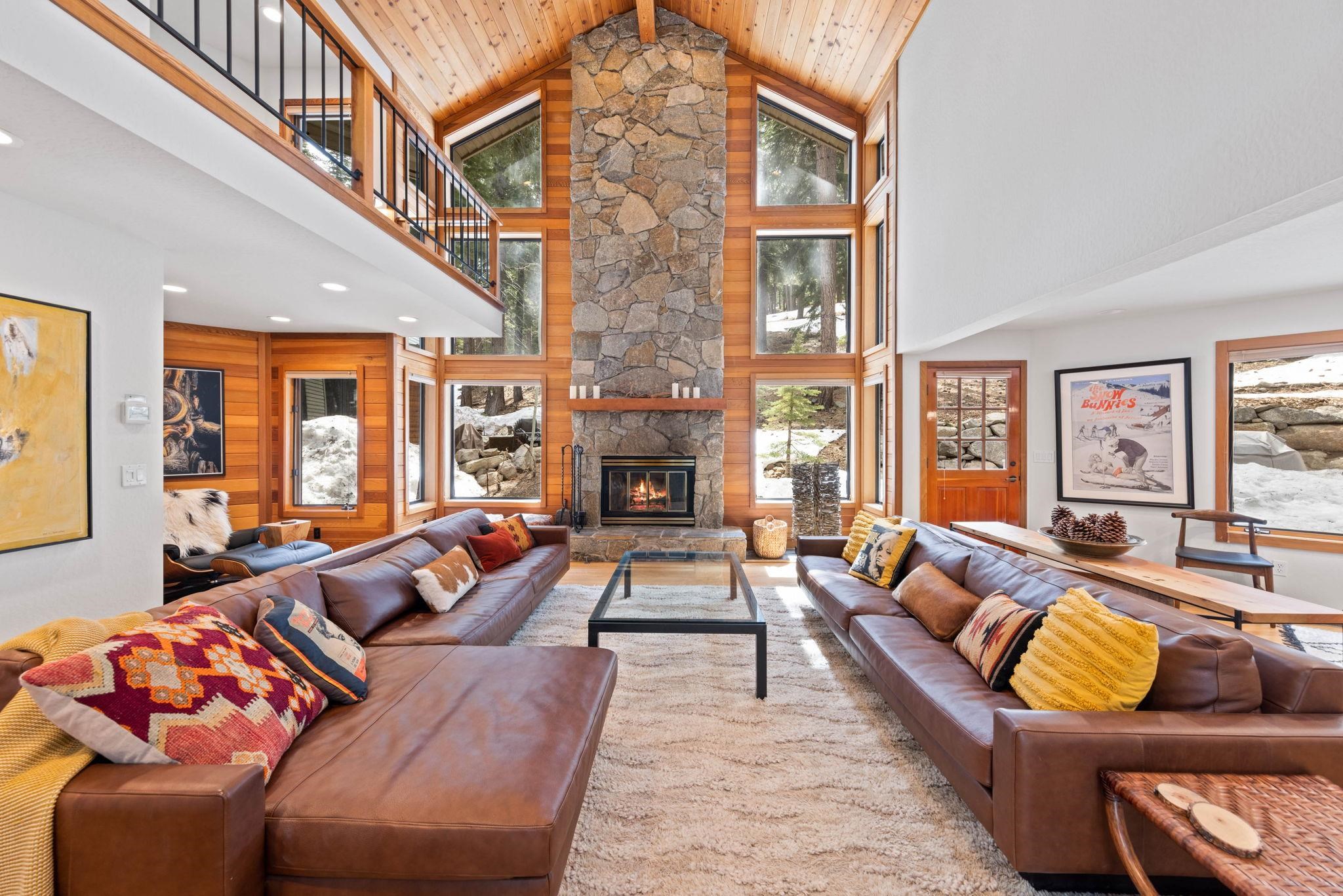 a living room with furniture fireplace and a large window