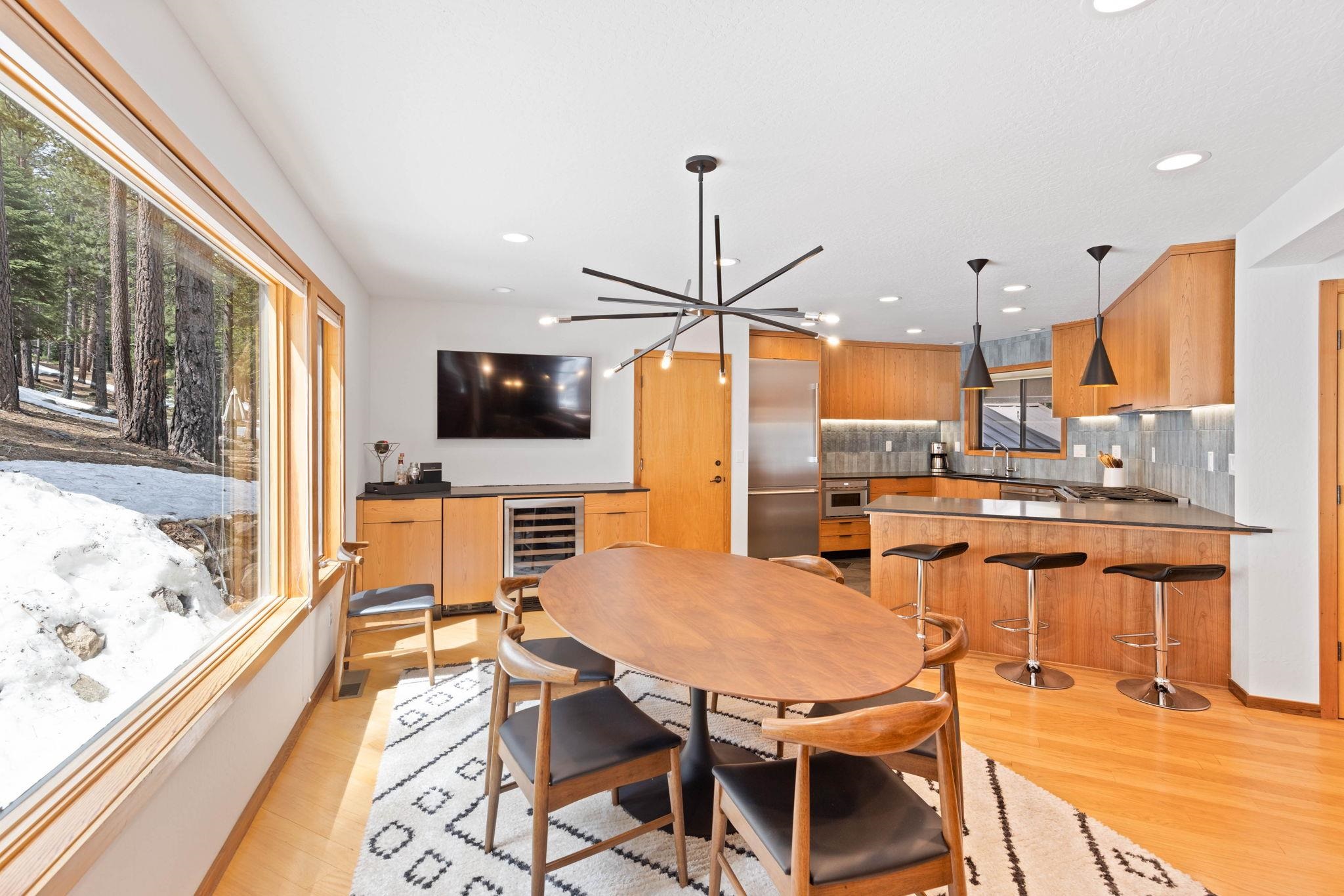 737 Conifer Truckee, CA 96161 - Photo 9 of 21 a dining room with stainless steel appliances kitchen island granite countertop a table chairs and a refrigerator