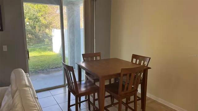 a view of a dining room with furniture and a window