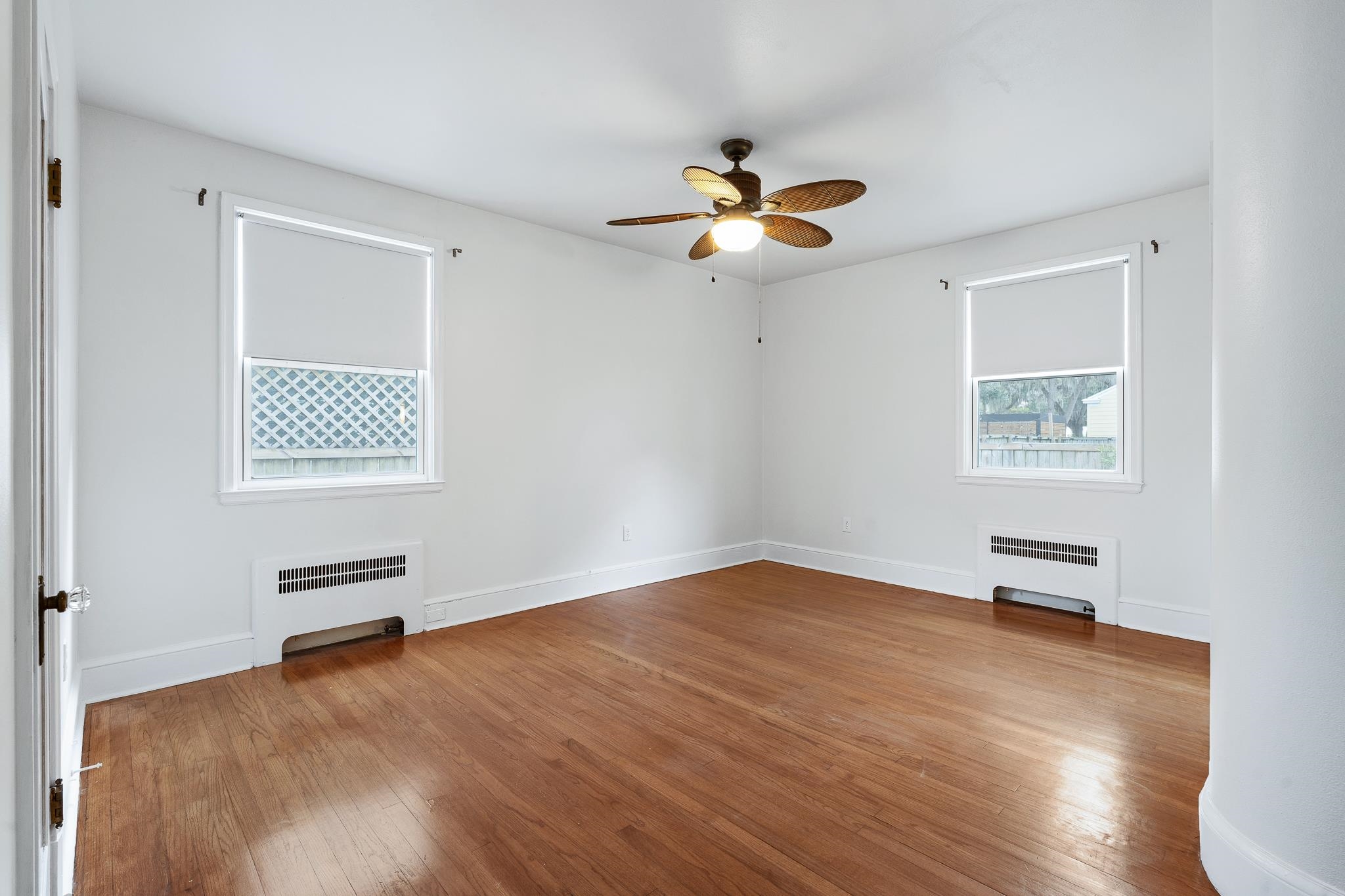 25 May Street St. Augustine, FL 32084 - Photo 23 of 38 wooden floor in an empty room with a window