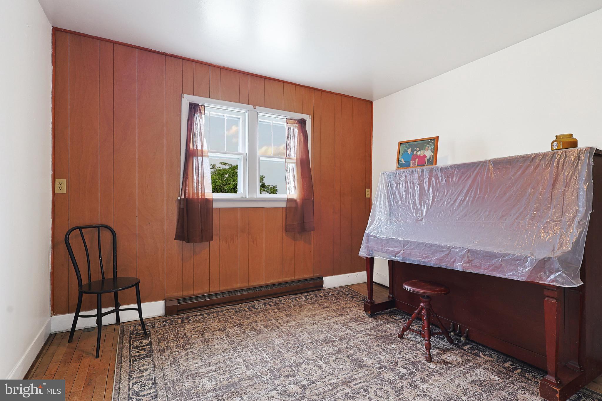 159 Rocket Center Road Keyser, WV 26726 - Photo 14 of 64 a room with a chair and a potted plant next to a window