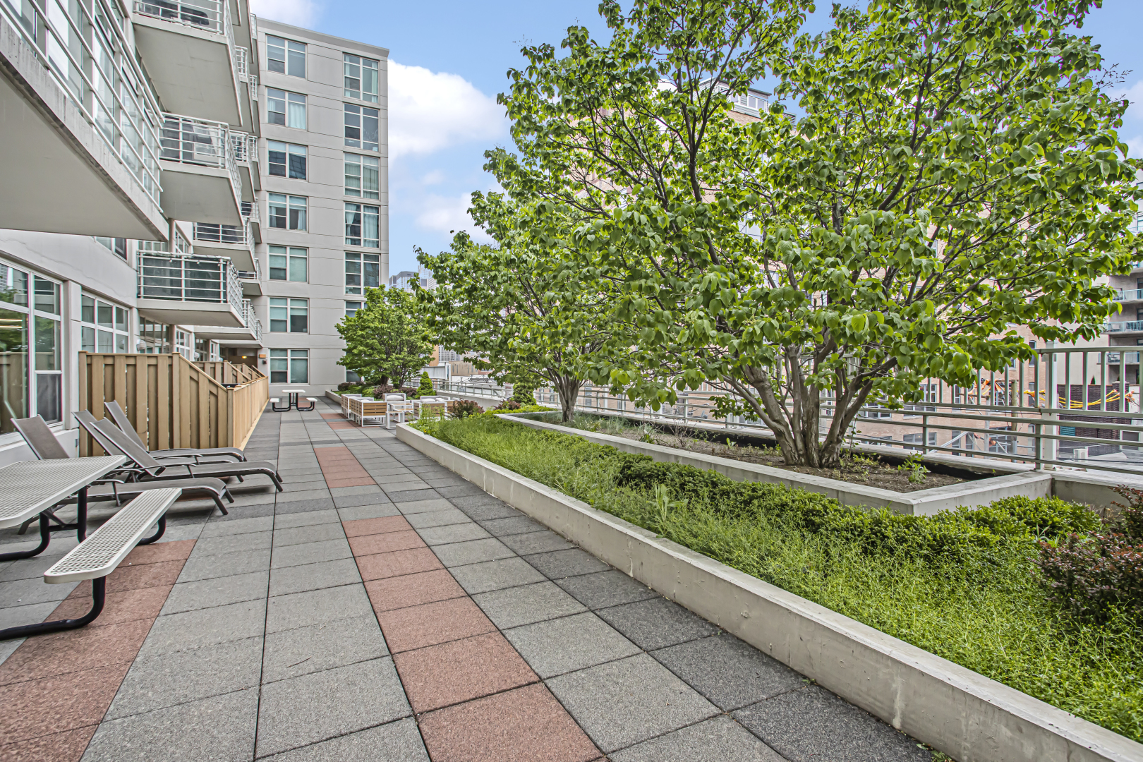 909 West Washington Boulevard, Unit 513 Chicago, IL 60607 - Photo 22 of 25 a view of a patio with dining table and chairs with wooden fence and plants