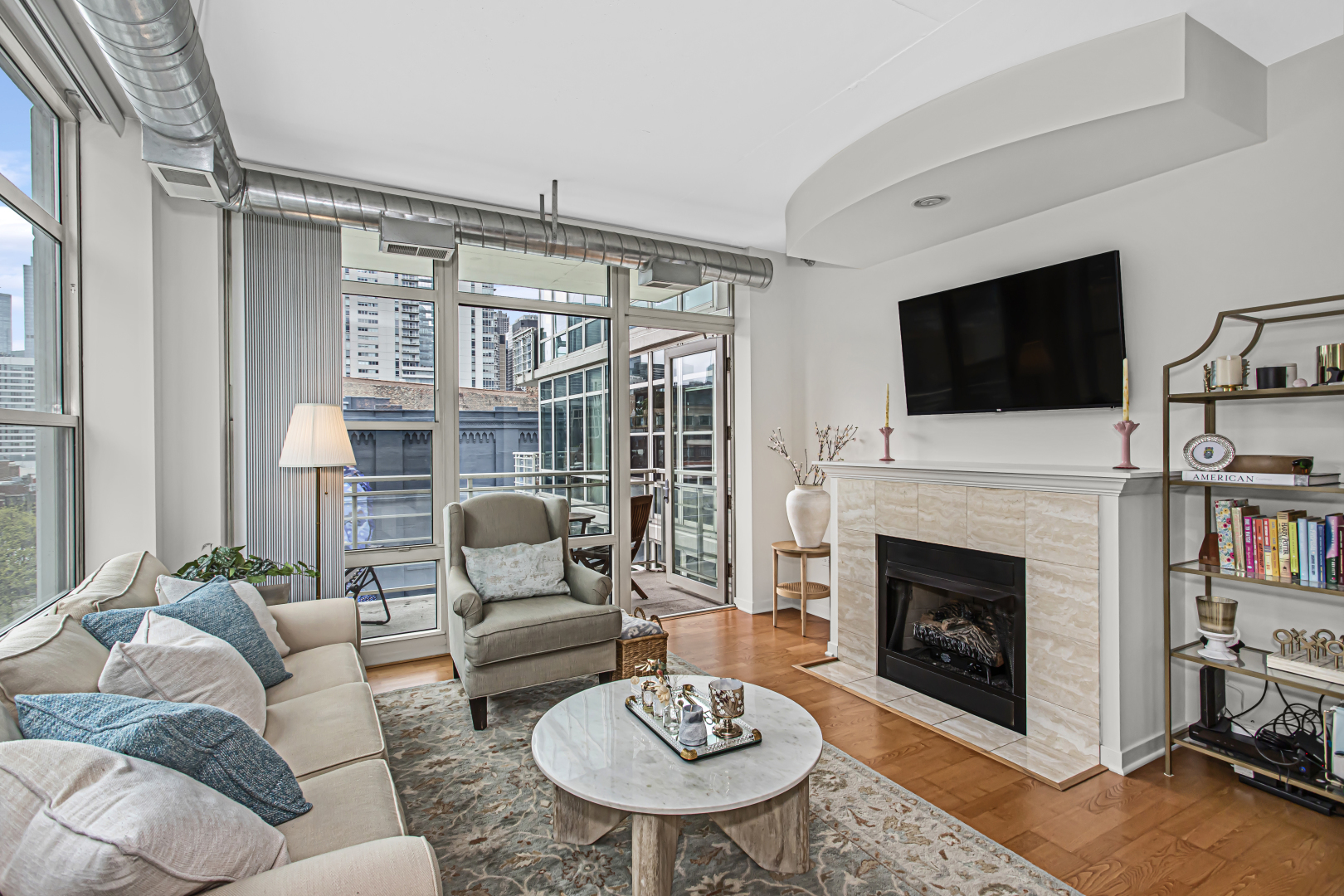 909 West Washington Boulevard, Unit 513 Chicago, IL 60607 - Photo 4 of 25 a living room with furniture a fireplace and a flat screen tv