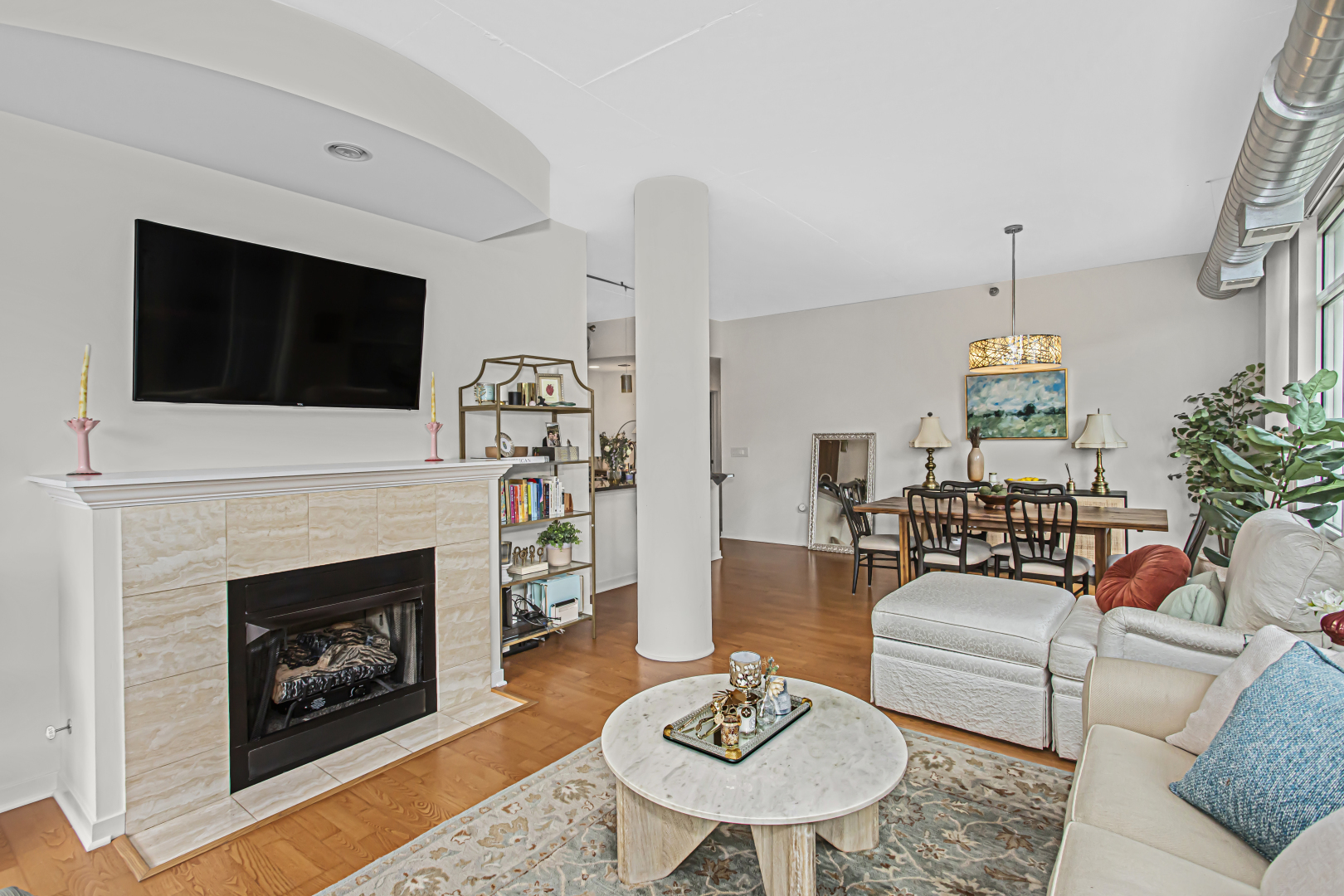 909 West Washington Boulevard, Unit 513 Chicago, IL 60607 - Photo 5 of 25 a living room with furniture a fireplace and a flat screen tv