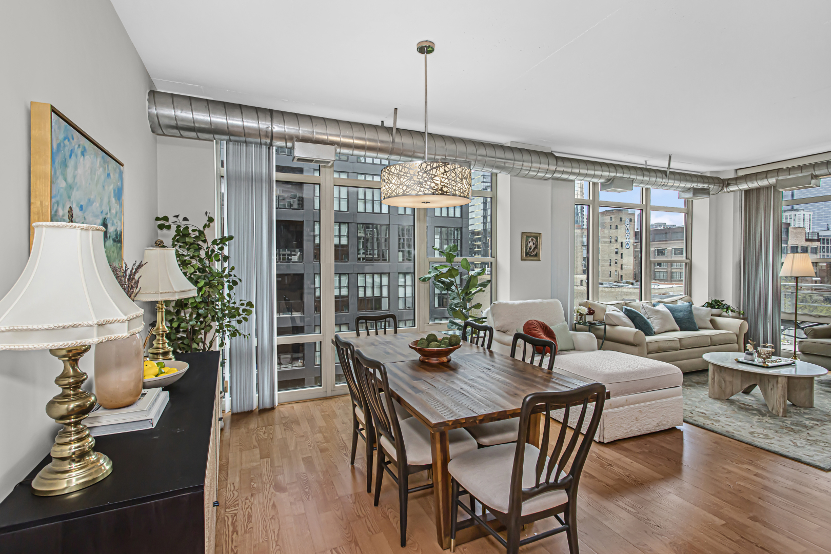 909 West Washington Boulevard, Unit 513 Chicago, IL 60607 - Photo 7 of 25 a dining room with furniture wooden floor and a chandelier