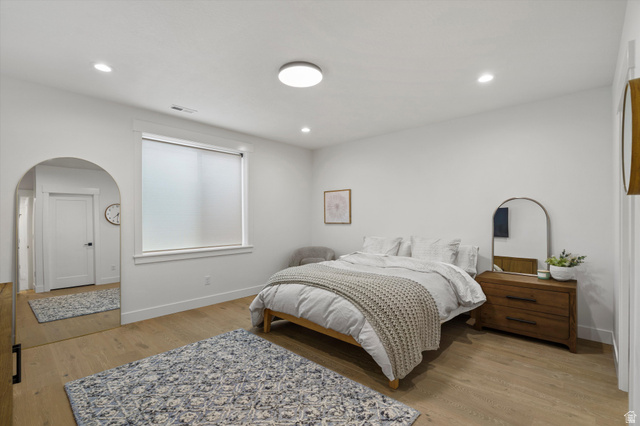 3349 Oxford Loop Morgan, UT 84050 - Photo 25 of 47 Bedroom featuring arched walkways, light wood-type flooring, and recessed lighting
