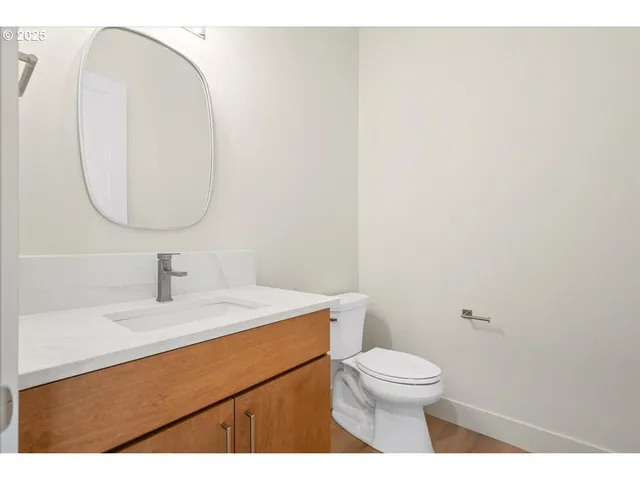 a bathroom with a toilet a sink and a mirror