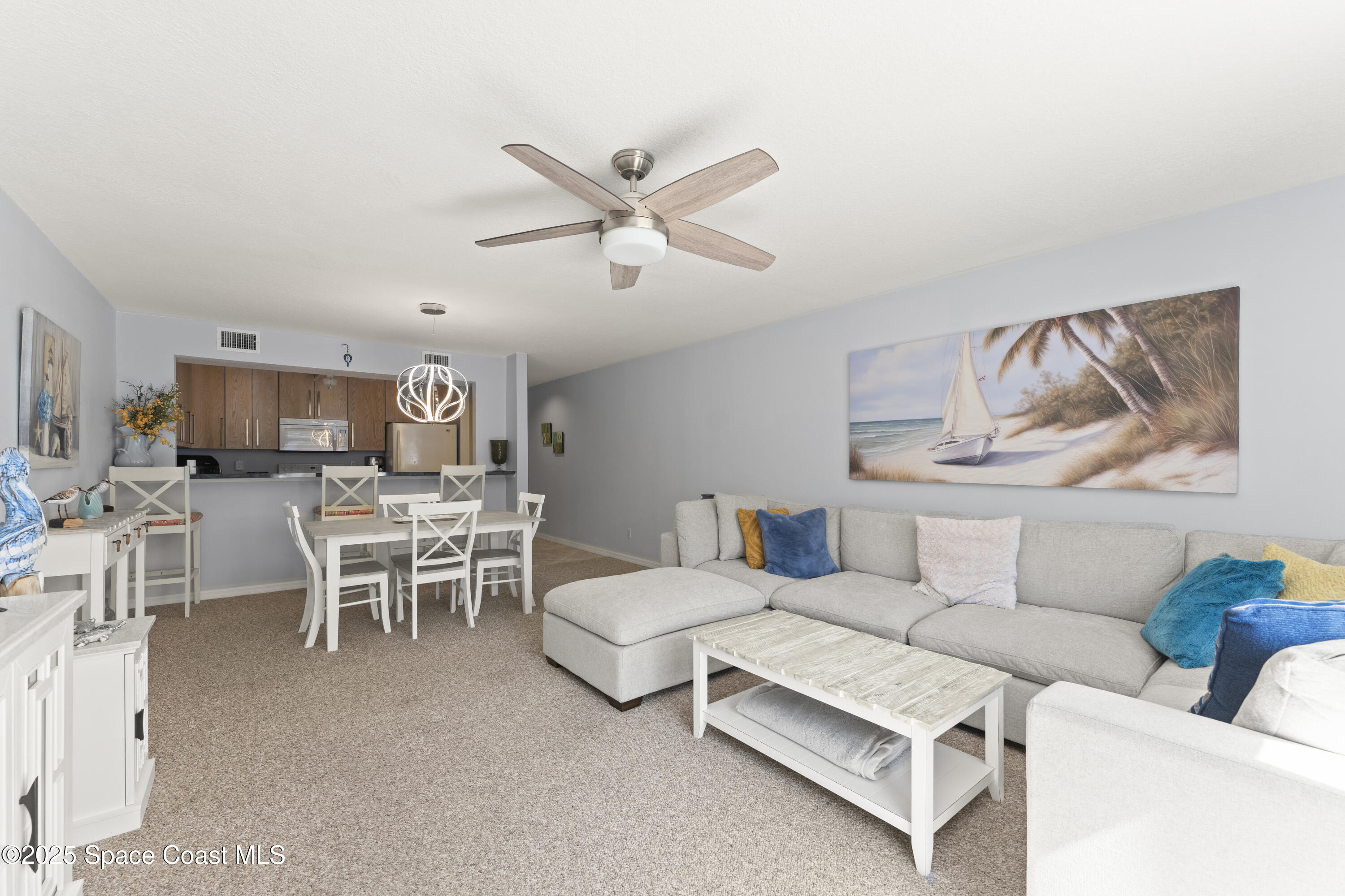 135 Escambia Lane, Unit 204 Cocoa Beach, FL 32931 - Photo 11 of 23 a living room with furniture and a large window