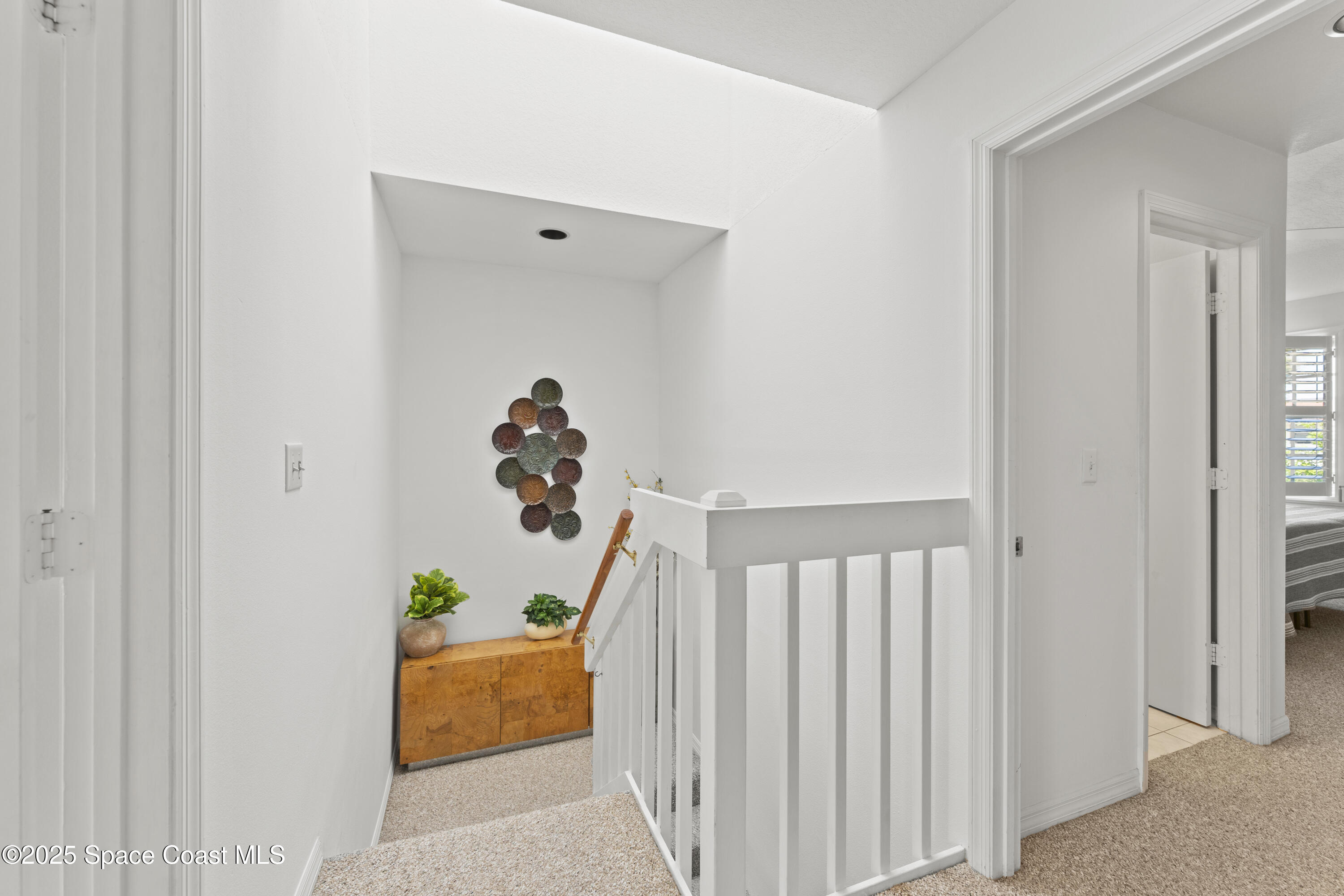 135 Escambia Lane, Unit 204 Cocoa Beach, FL 32931 - Photo 12 of 23 a view of entryway with wooden floor