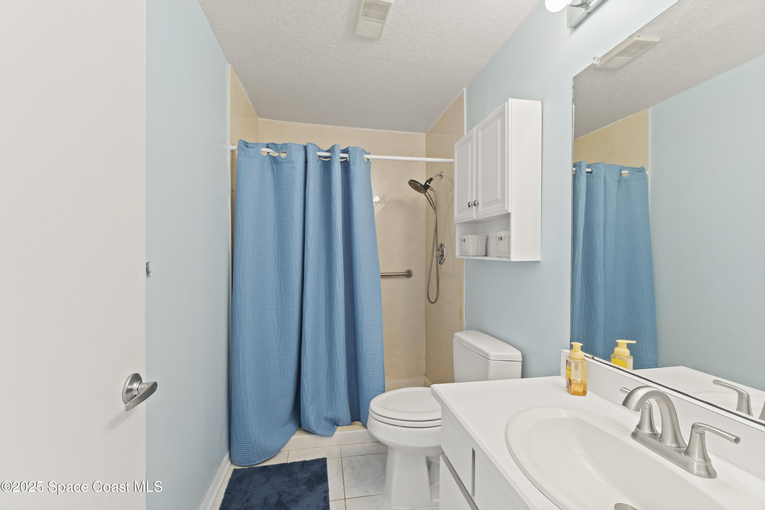 135 Escambia Lane, Unit 204 Cocoa Beach, FL 32931 - Photo 14 of 23 a bathroom with a sink toilet and shower