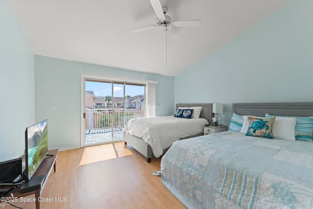 a bedroom with two beds and a large window