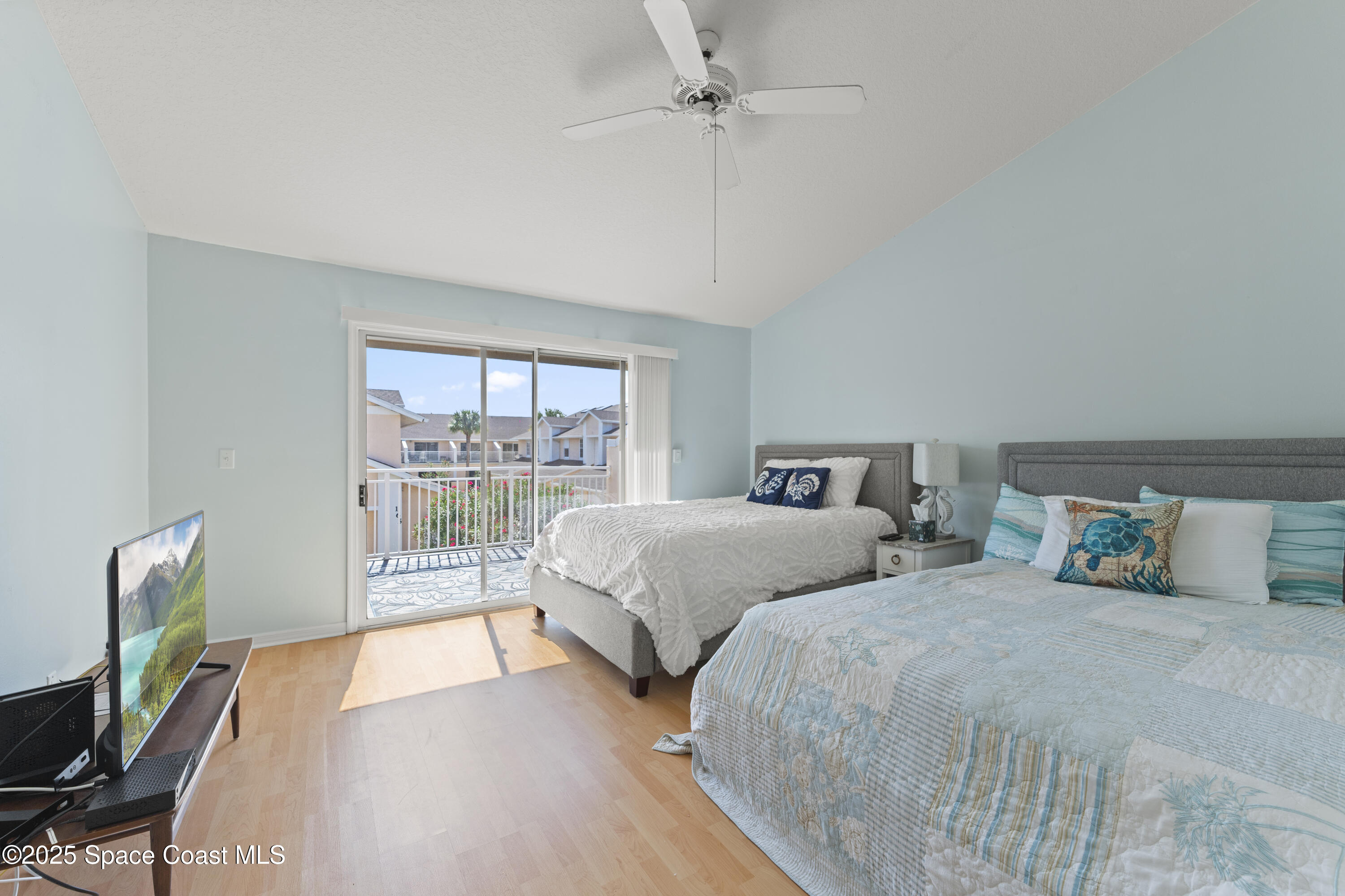 135 Escambia Lane, Unit 204 Cocoa Beach, FL 32931 - Photo 15 of 23 a bedroom with two beds and a large window