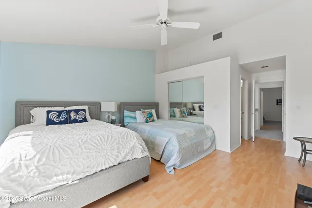 a bedroom with a bed and a mirror