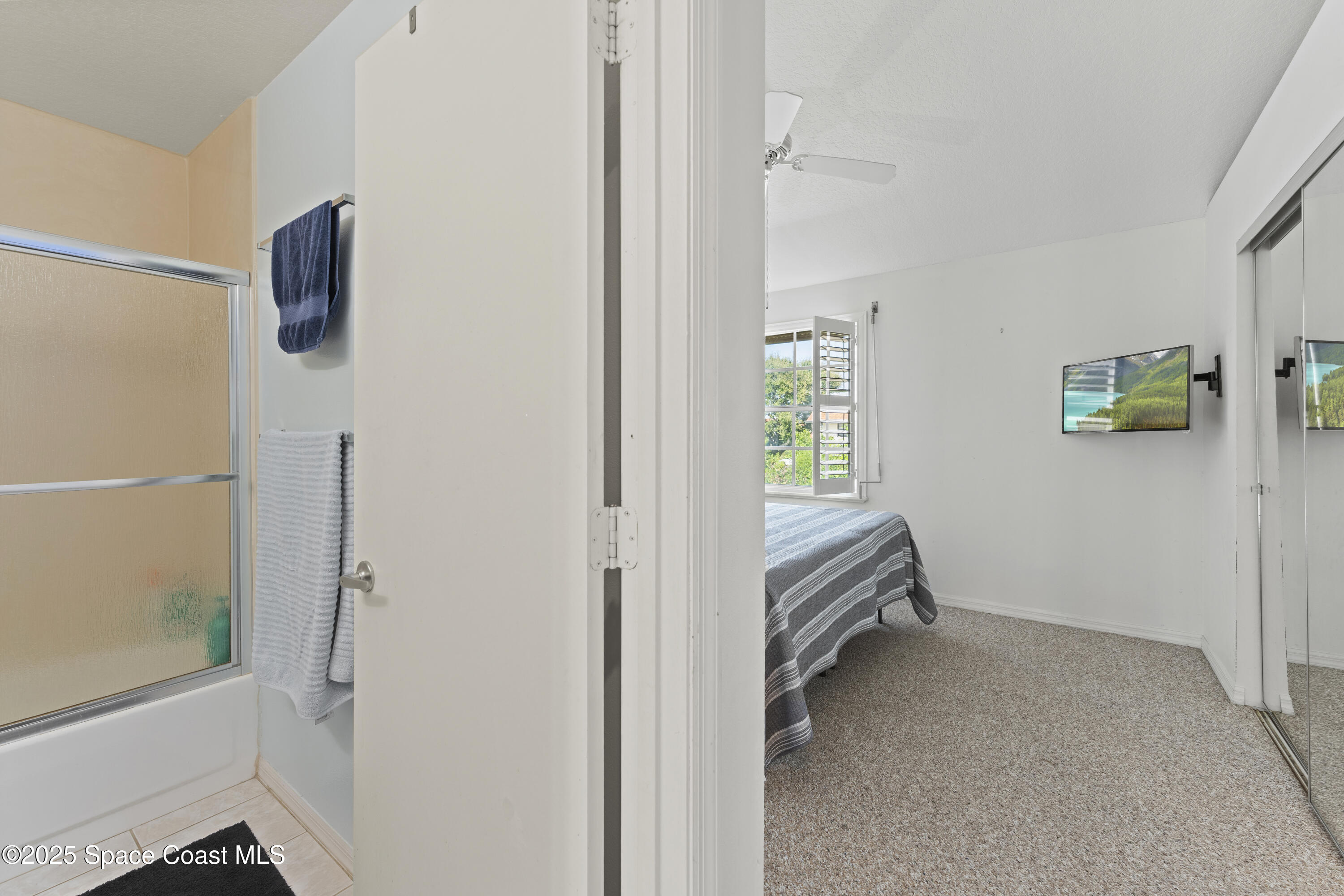 135 Escambia Lane, Unit 204 Cocoa Beach, FL 32931 - Photo 19 of 23 a room that has a bed and a window in it