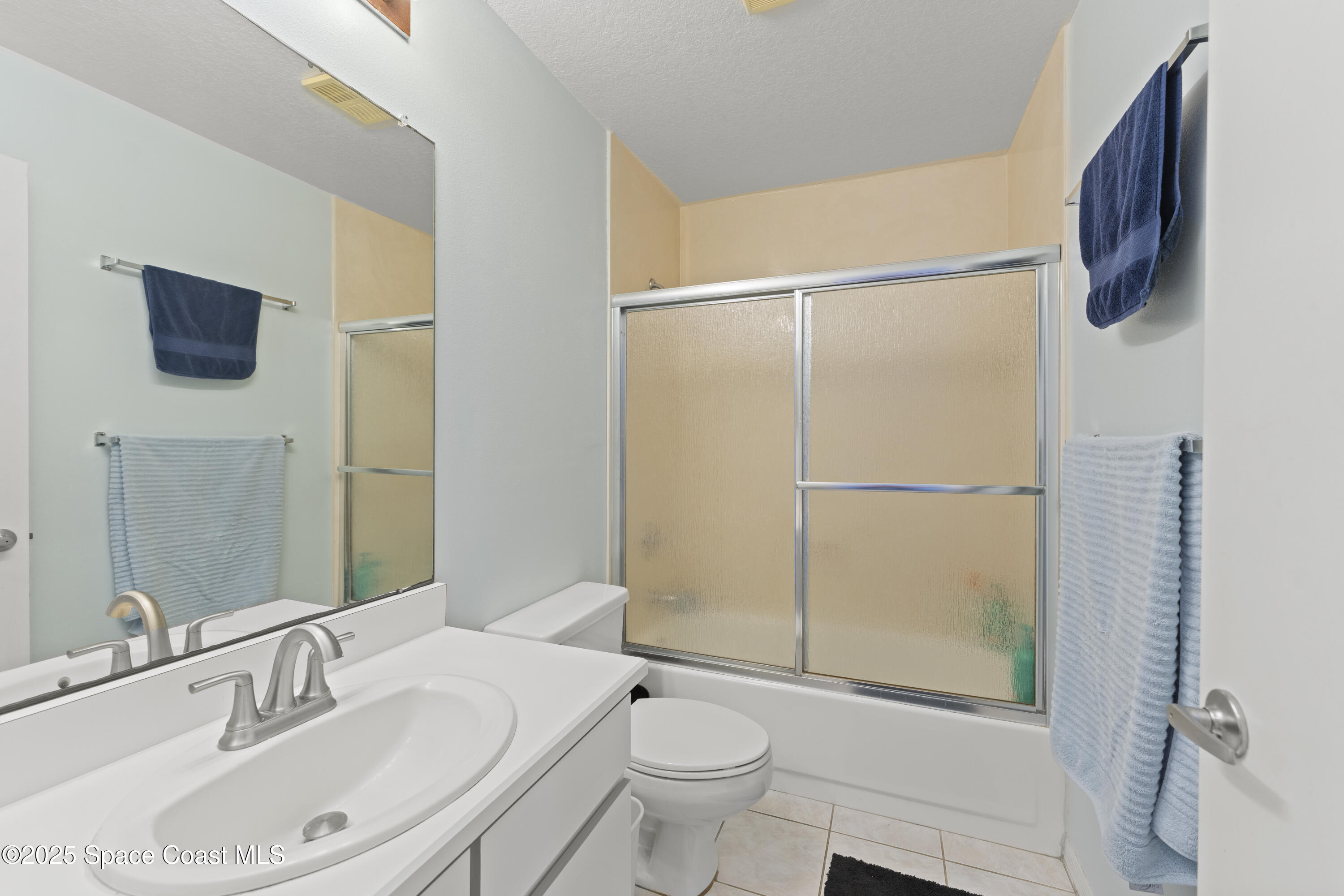 135 Escambia Lane, Unit 204 Cocoa Beach, FL 32931 - Photo 20 of 23 a bathroom with a sink toilet and shower