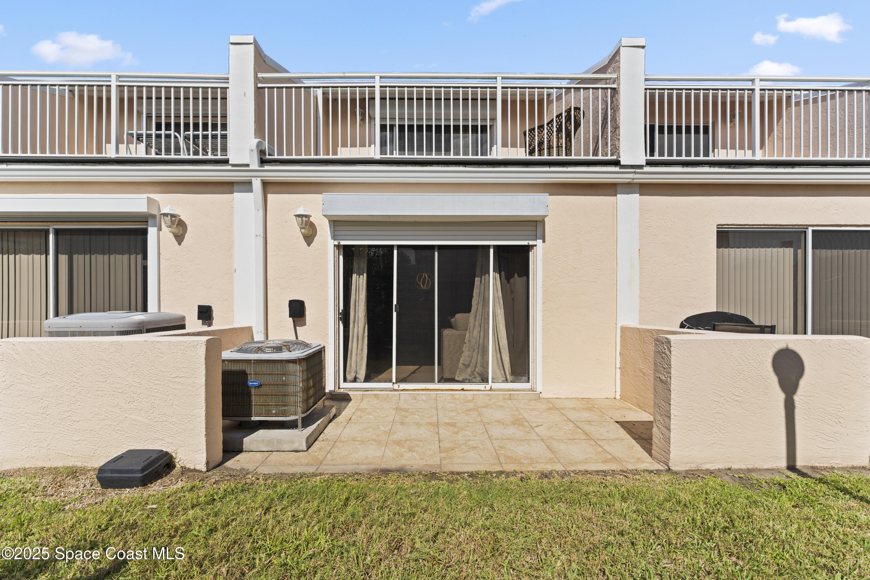 135 Escambia Lane, Unit 204 Cocoa Beach, FL 32931 - Photo 23 of 23 a front view of a house with garden