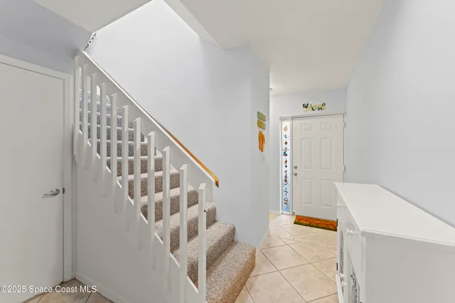 a view of staircase with white walls and windows