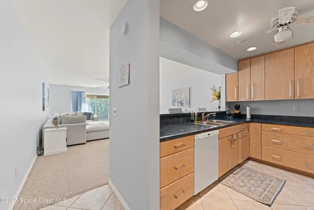 a large white kitchen with cabinets