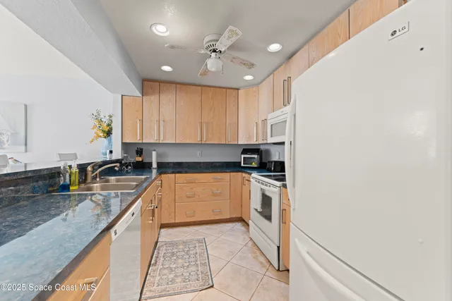 a kitchen with stainless steel appliances granite countertop a sink and cabinets