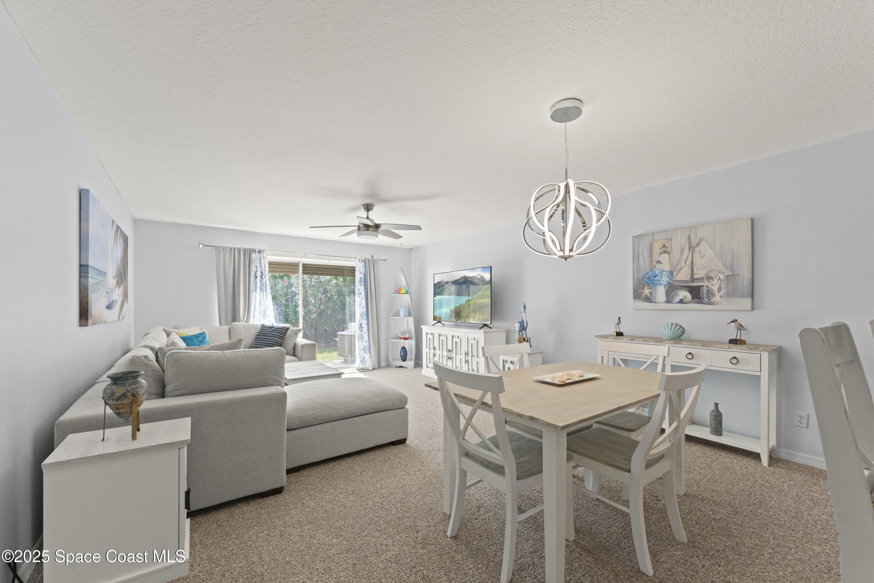 135 Escambia Lane, Unit 204 Cocoa Beach, FL 32931 - Photo 10 of 23 a view of a dining room with furniture window and wooden floor