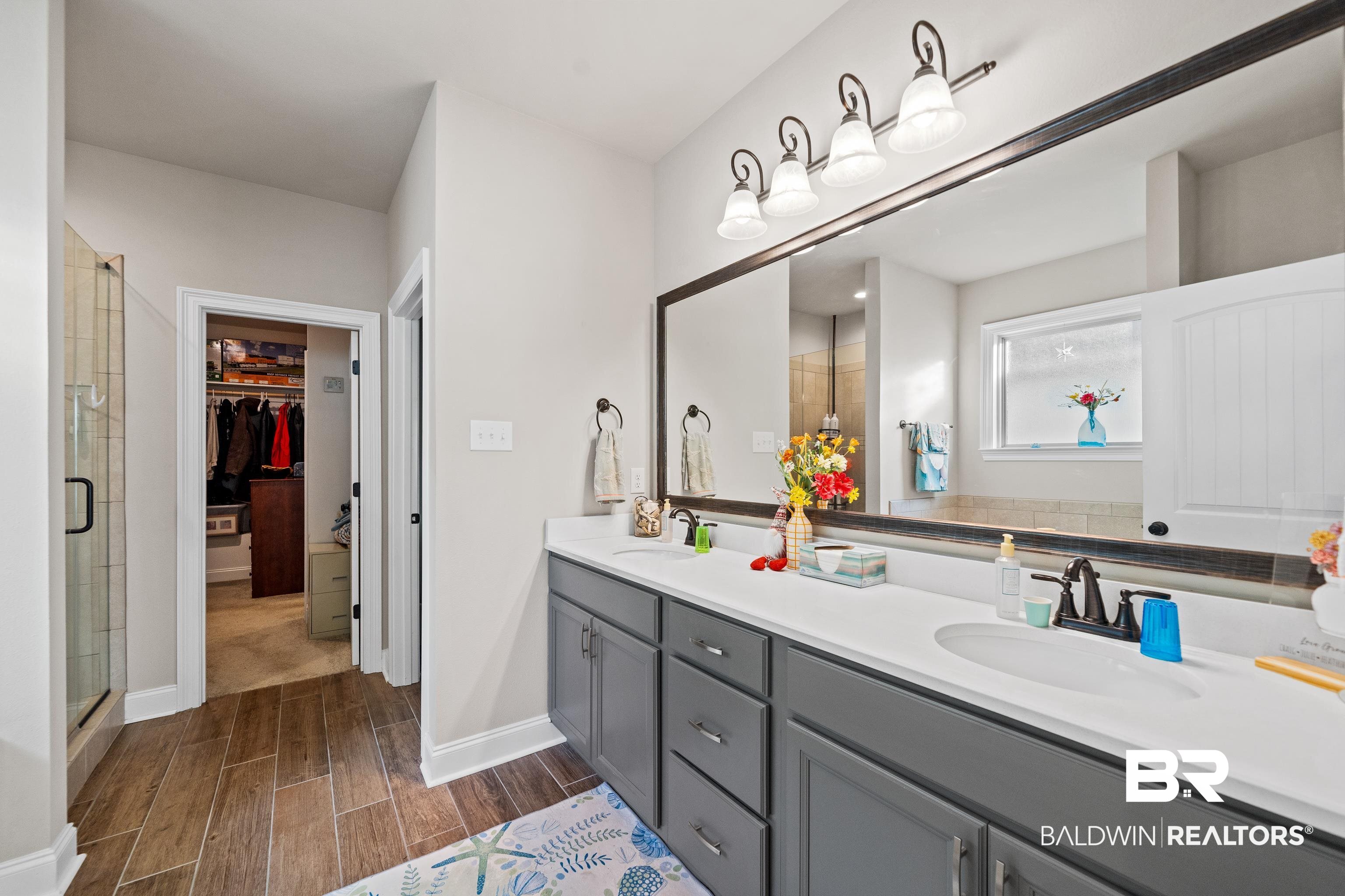 1390 Aldon Street Foley, AL 36535 - Photo 15 of 31 Full bath featuring double vanity, wood finish floors, a walk in closet, and a stall shower