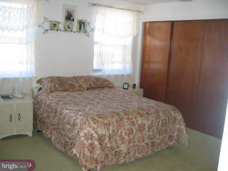 557 Snowden Road Upper Darby, PA 19082 - Photo 5 of 6 a bed sitting in a bedroom next to a window