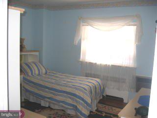 557 Snowden Road Upper Darby, PA 19082 - Photo 6 of 6 a bedroom with a bed and a window