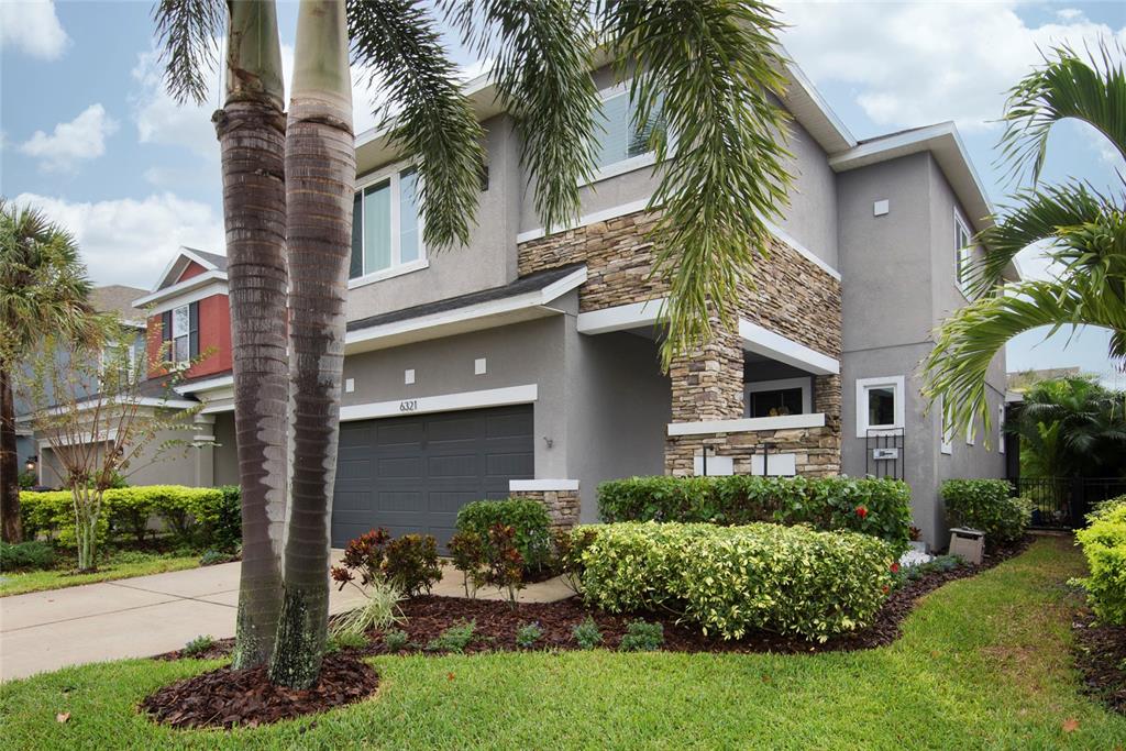 a front view of a house with garden