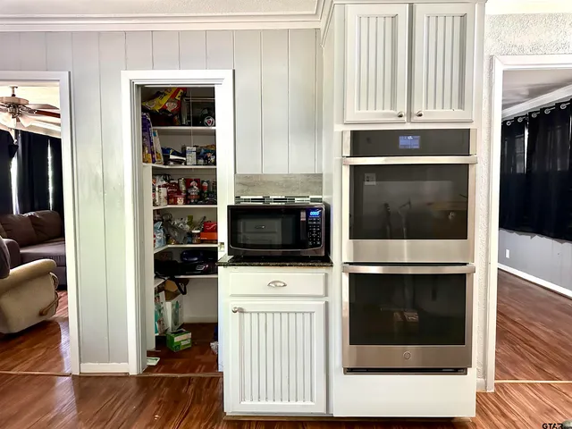 a kitchen with stainless steel appliances a stove and a microwave
