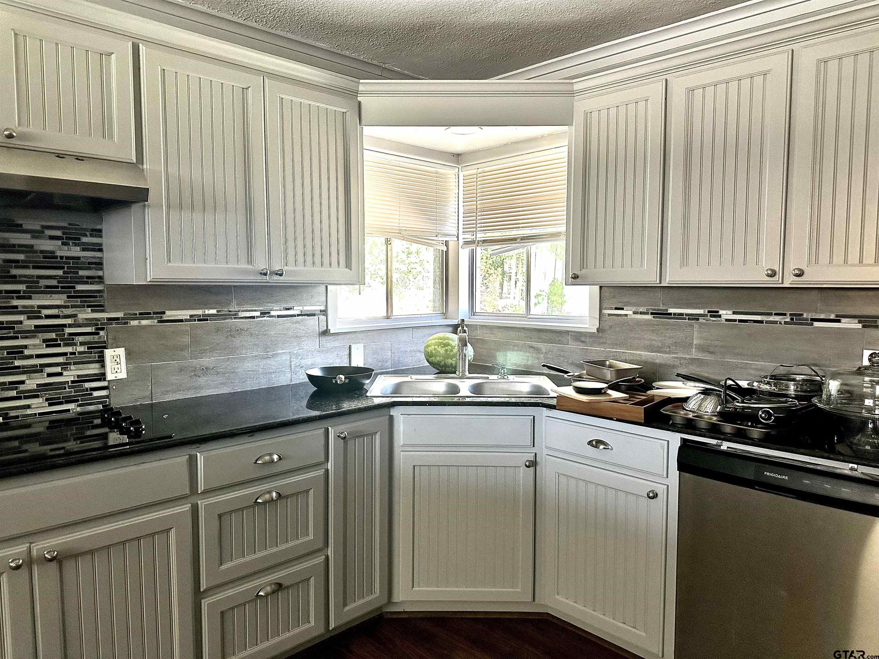 3112 Hallmark Place Tyler, TX 75701 - Photo 15 of 16 a kitchen with granite countertop cabinets stainless steel appliances a sink and window