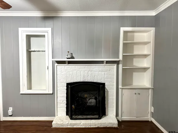 a living room with a fireplace in it and a window