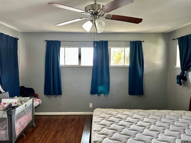 a bedroom with a bed and a chandelier