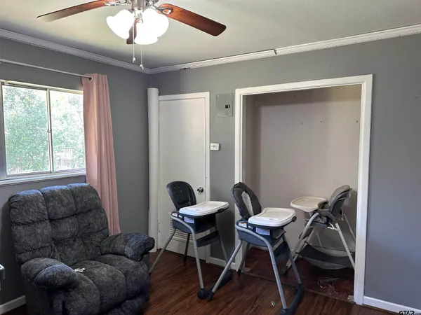 a work room with furniture and a large window