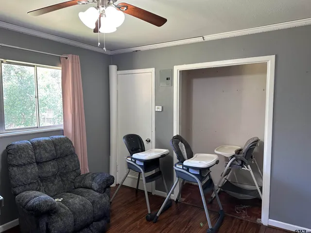 a work room with furniture and a large window