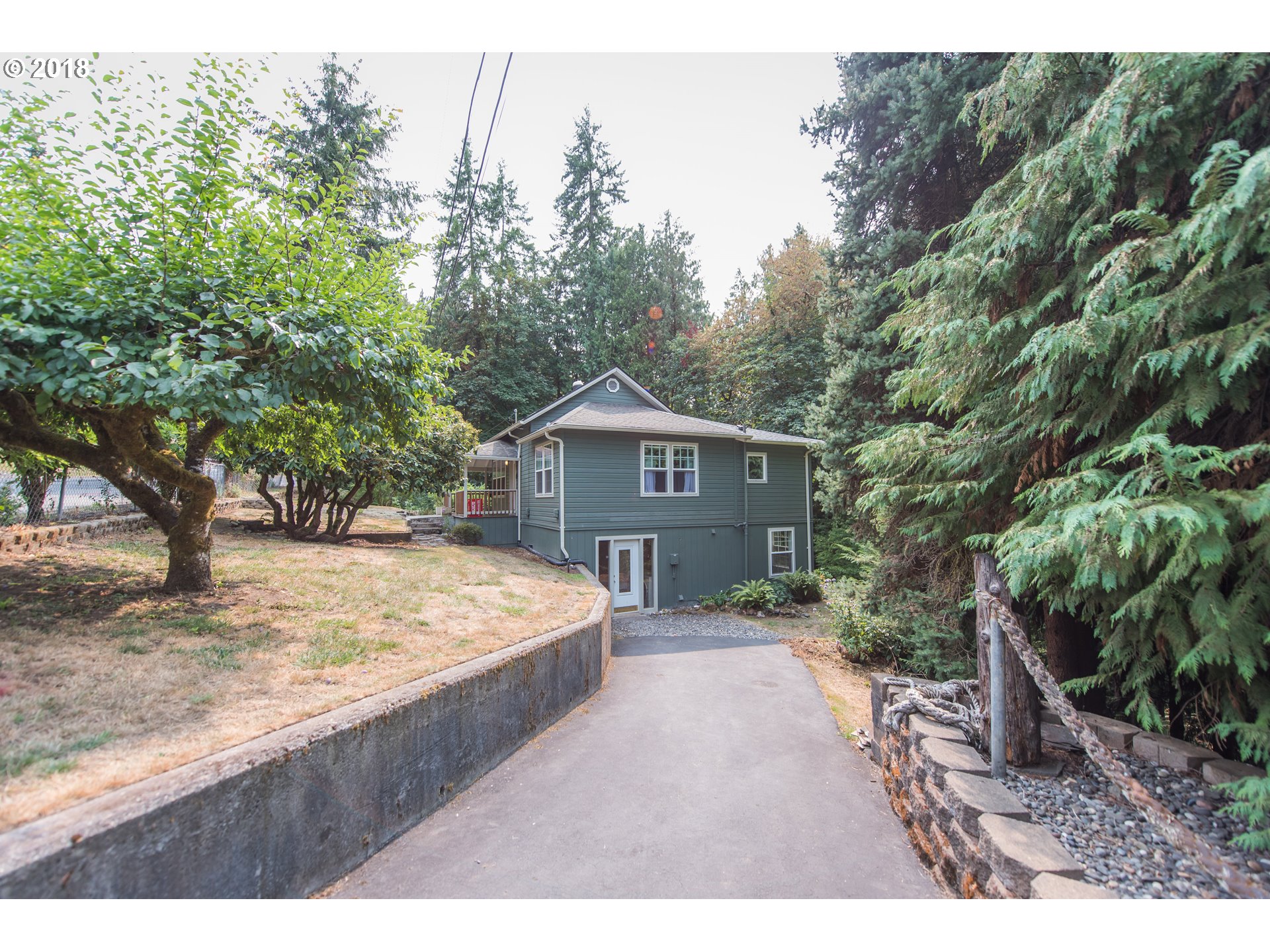 29503 Old Rainier Road Rainier, OR 97048 - Photo 3 of 22 a view of a wooden house and a yard