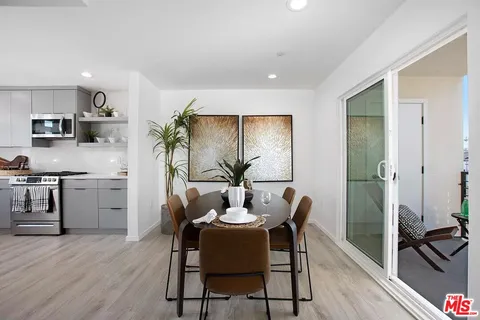 a view of a dining room with furniture and wooden floor