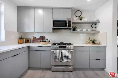 a kitchen with cabinets and stainless steel appliances