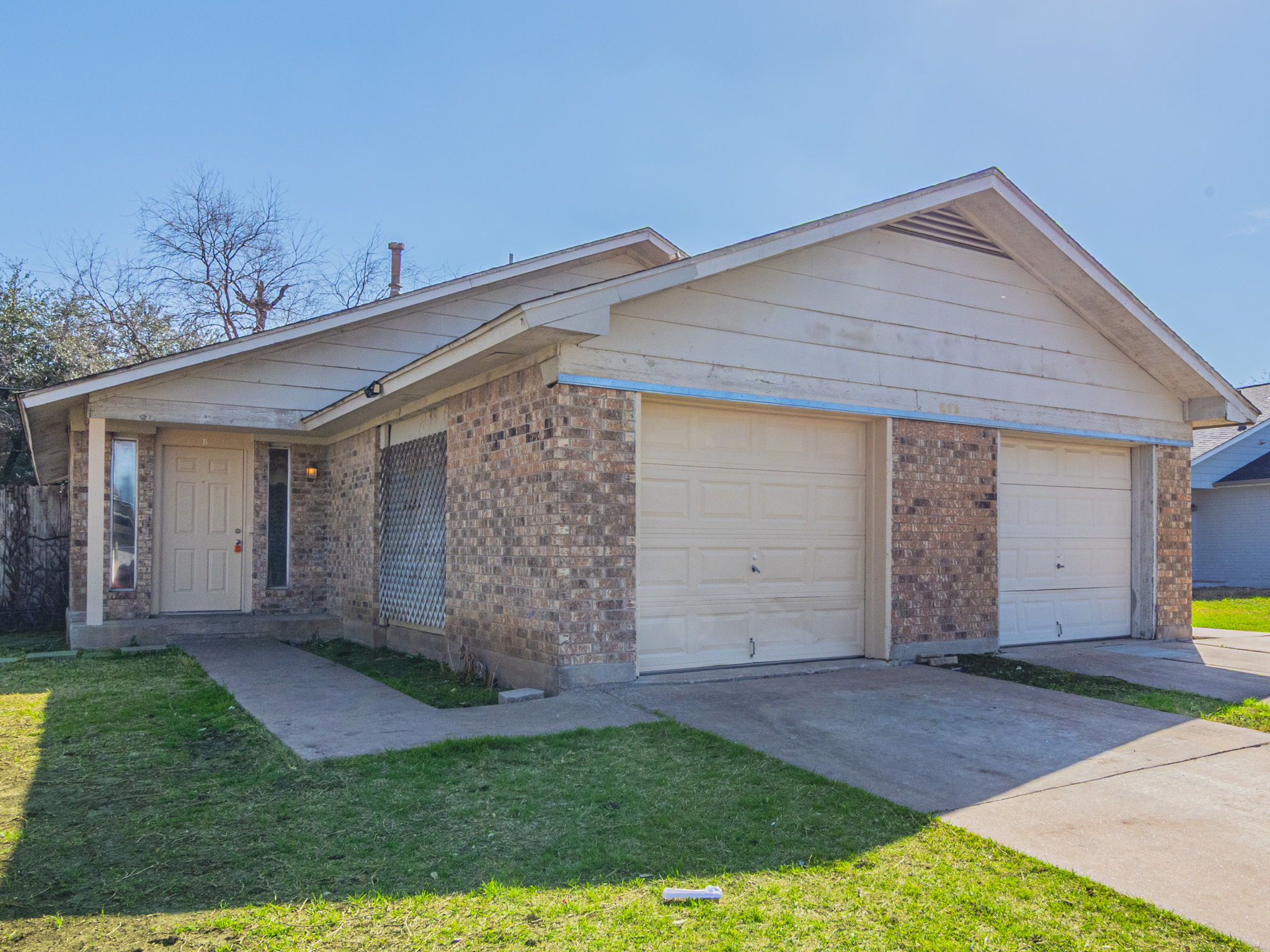 605 Misty Morning Way, Unit B Round Rock, TX 78664 - Photo 1 of 1 Single story home featuring brick siding, a front lawn, concrete driveway, and a garage