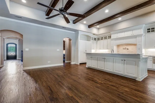 a view of a room with wooden floors