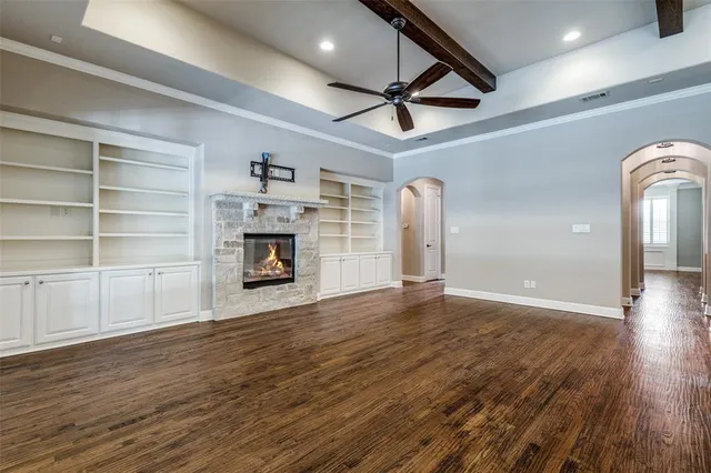a view of an empty room with a fireplace and a window