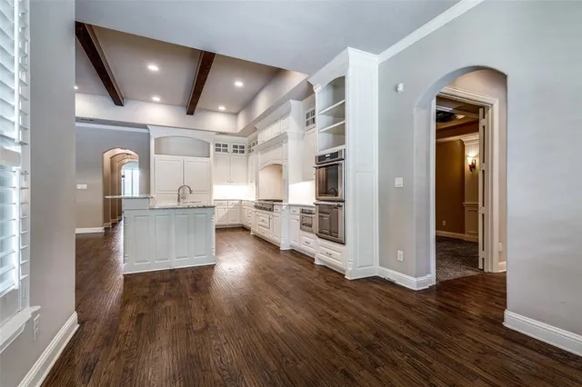 a view of a kitchen with furniture and wooden floor