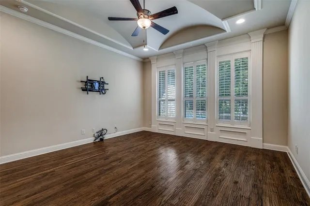 a view of room with hardwood floor and ceiling fan